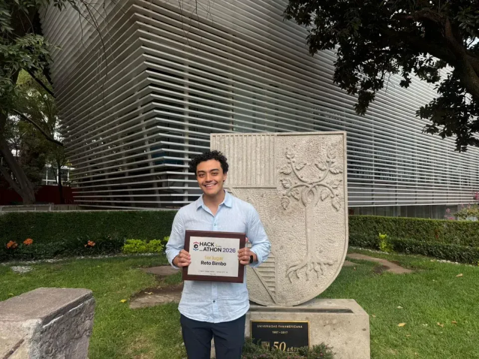 Luis holding the 2026 first-place Bimbo challenge award at Universidad Panamericana